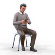 ManSitiing_1.12.136.jpg A Man sitting on a chair with smartphone