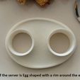 shape_display_large.jpg Boiled Egg Server - Neatly holds both parts of a cut boiled egg while it's being eaten.