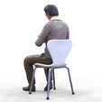 ManSitiing_1.12.56.jpg A Man sitting on a chair with smartphone