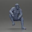 3DG-0007.jpg Street performer crouching low in blue puffer jacket athletic stance sitting