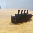 Small compressed Titanic and scale example of the iceberg