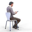 ManSitiing_1.12.96.jpg A Man sitting on a chair with smartphone