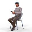 ManSitiing_1.12.16.jpg A Man sitting on a chair with smartphone