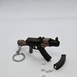 20250902_000202.jpg AK-47 Keychain — Functional Blaster Toy
