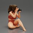 3DG-0003.jpg Woman photographer in bikini sitting and holding a camera