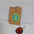 6cb6af52-ee8e-4186-8f72-088da0021145.jpg Alliance WoW - Boucles d'oreilles et porte-clés