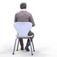 ManSitiing_1.12.76.jpg A Man sitting on a chair with smartphone