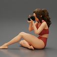3DG-0001.jpg Woman photographer in bikini sitting and holding a camera