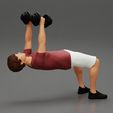 Girl-0001.jpg Muscular man working out in gym doing exercises with dumbbell chest