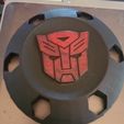 received_1695090371235943-1.jpeg Hubcap 6x4.5in   Dodge, Nissan Autobot Transformers