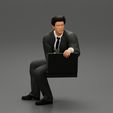 3DG-0006.jpg businessman sitting and holding briefcase of money