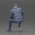 3DG-0010.jpg Street performer crouching low in blue puffer jacket athletic stance sitting