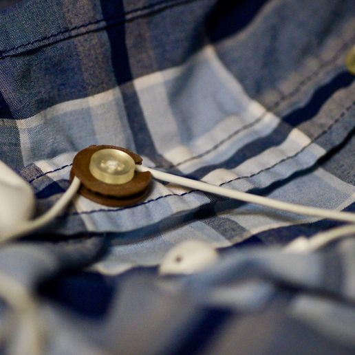 Headphone management - button attachment