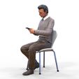 ManSitiing_1.12.21.jpg A Man sitting on a chair with smartphone