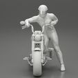 3DG-0008.jpg Motorbiker standing pushing his motorbike