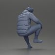 3DG-0009.jpg Street performer crouching low in blue puffer jacket athletic stance sitting