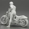 3DG-0012.jpg Motorbiker standing pushing his motorbike