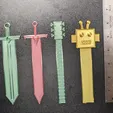 il_fullxfull.6211666215_d9s6.webp Bookmarks - Sword, Robot & Guitar STL Pack (4)