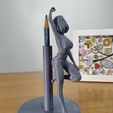 pic3.jpg Office girl in tight outfit leaning on a pencil holder stationary