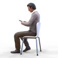 ManSitiing_1.12.41.jpg A Man sitting on a chair with smartphone