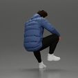 3DG-0003.jpg Street performer crouching low in blue puffer jacket athletic stance sitting