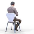 ManSitiing_1.12.86.jpg A Man sitting on a chair with smartphone
