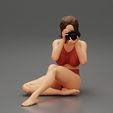 3DG-0002.jpg Woman photographer in bikini sitting and holding a camera