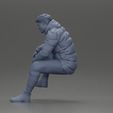 3DG-0011.jpg Street performer crouching low in blue puffer jacket athletic stance sitting