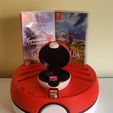 IMG_20230411_135524.jpg Stand for Nintendo Switch games in the shape of a Pokeball