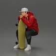 3DG-0001.jpg man in hoodie and cap sitting and putting his hand on the skateboard
