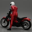3DG-0006.jpg Motorbiker standing pushing his motorbike
