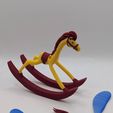 PXL_20260216_203929610.jpg Alice in Wonderland rocking horse figurine