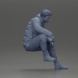 3DG-0008.jpg Street performer crouching low in blue puffer jacket athletic stance sitting