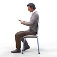 ManSitiing_1.12.36.jpg A Man sitting on a chair with smartphone