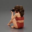 3DG-0006.jpg Woman photographer in bikini sitting and holding a camera