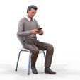 ManSitiing_1.12.131.jpg A Man sitting on a chair with smartphone