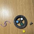 Photo-of-3D-printed-ORBIT-spinner-kit-parts-with-braille-ring-silver-hub-base-yellow-sun-cap-and-pur.jpg Fidget spinner multisensoriale con ingranaggi planetari ORBIT. Giocattolo OpenSCAD parametrico stampato in loco con numeri in braille, cappucci celesti tattili e feedback acustico