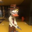 Inspecteur Duck avec une arme à feu