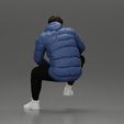 3DG-0004.jpg Street performer crouching low in blue puffer jacket athletic stance sitting