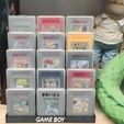 Juegos-con-funda.jpg Game Boy game display stand with Game Boy case