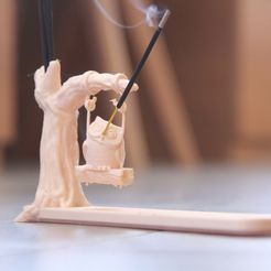 Porte-encens en forme d'arbre avec une chouette, bâtonnet d'encens allumé émettant de la fumée, arrière-plan flou