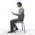 ManSitiing_1.12.31.jpg A Man sitting on a chair with smartphone