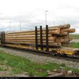 21436-LTTX-142397-flatcar-with-stakes-and-wood-pole-load-on-394-at-Mount-Pleasant-GO,-647pm.jpg 50-футовый вагон для бревен/труб в масштабе N с сцепками Micro-Trains
