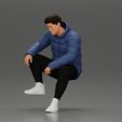 3DG-0006.jpg Street performer crouching low in blue puffer jacket athletic stance sitting