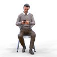 ManSitiing_1.12.146.jpg A Man sitting on a chair with smartphone
