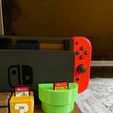 WhatsApp-Image-2023-04-04-at-1.13.31-PM.jpeg MARIO WORLD - NINTENDO SWITCH WALL AND TABLE STAND WITH DOCK + 25 GAMES