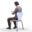 ManSitiing_1.12.51.jpg A Man sitting on a chair with smartphone