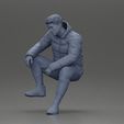 3DG-0012.jpg Street performer crouching low in blue puffer jacket athletic stance sitting