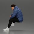3DG-0005.jpg Street performer crouching low in blue puffer jacket athletic stance sitting